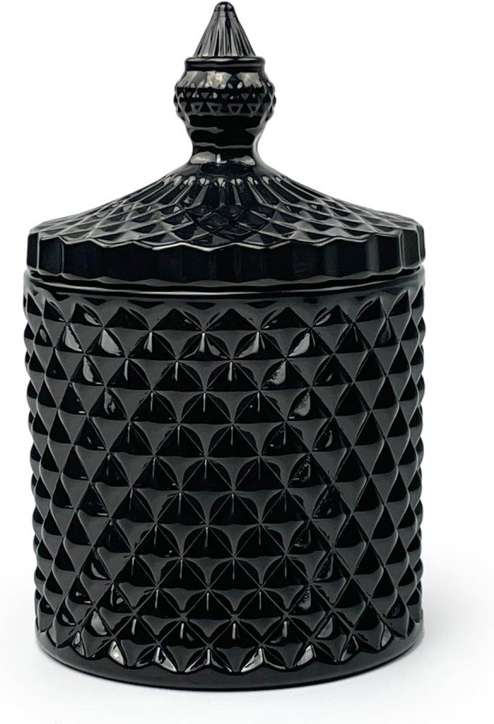 A decorative black glass jar with a textured, geometric design and a pointed lid.