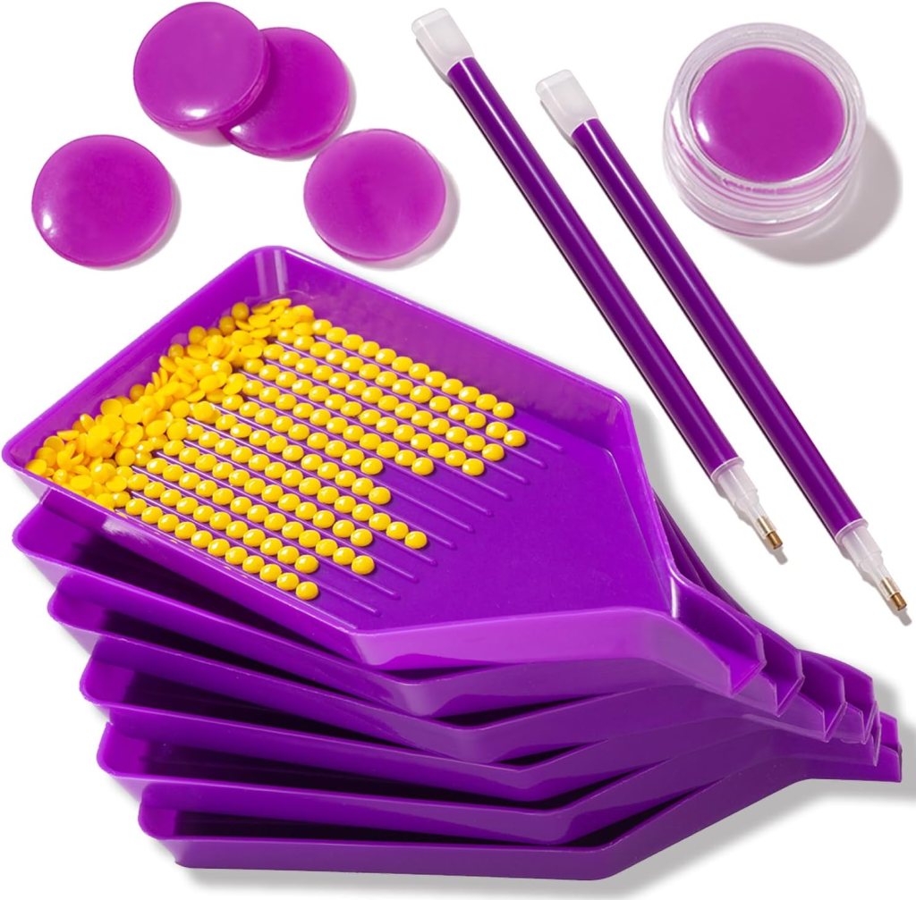 Collection of purple crafting tools including a tray, yellow beads, circular purple pieces, and pens.