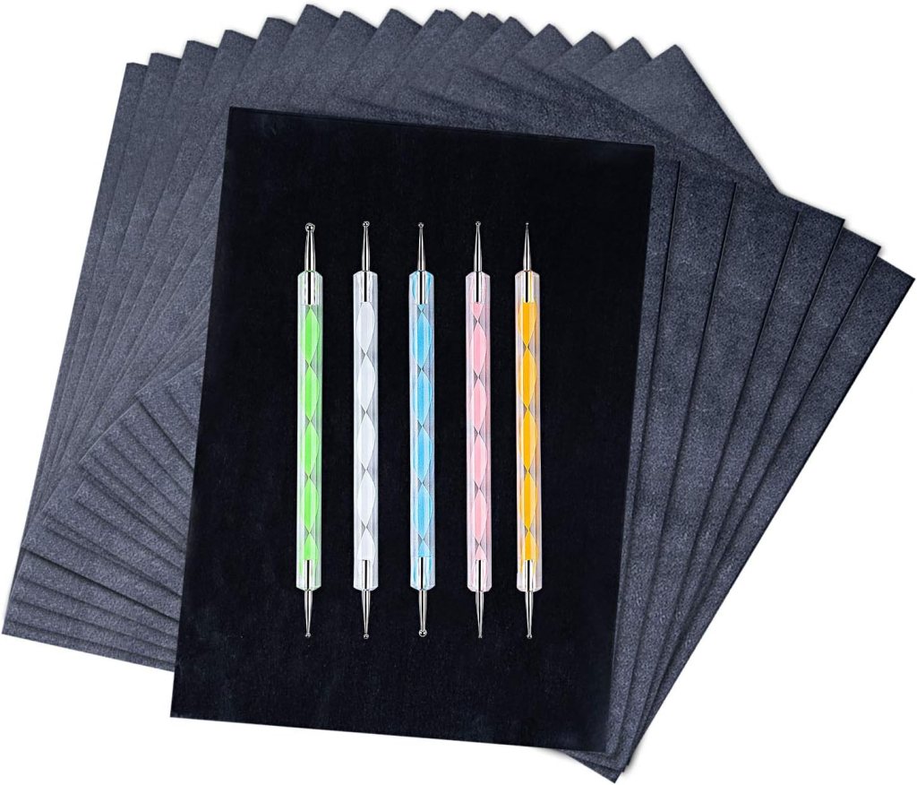 A set of four colorful pens with decorative details, placed on top of a stack of black sheets of paper.