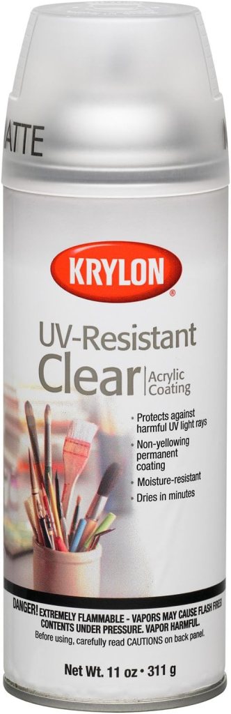 A spray can of Krylon UV-Resistant Clear acrylic coating, featuring a matte finish. The label highlights its protective features against UV light, non-yellowing properties, moisture resistance, and quick drying time. Includes a caution warning about flammability.