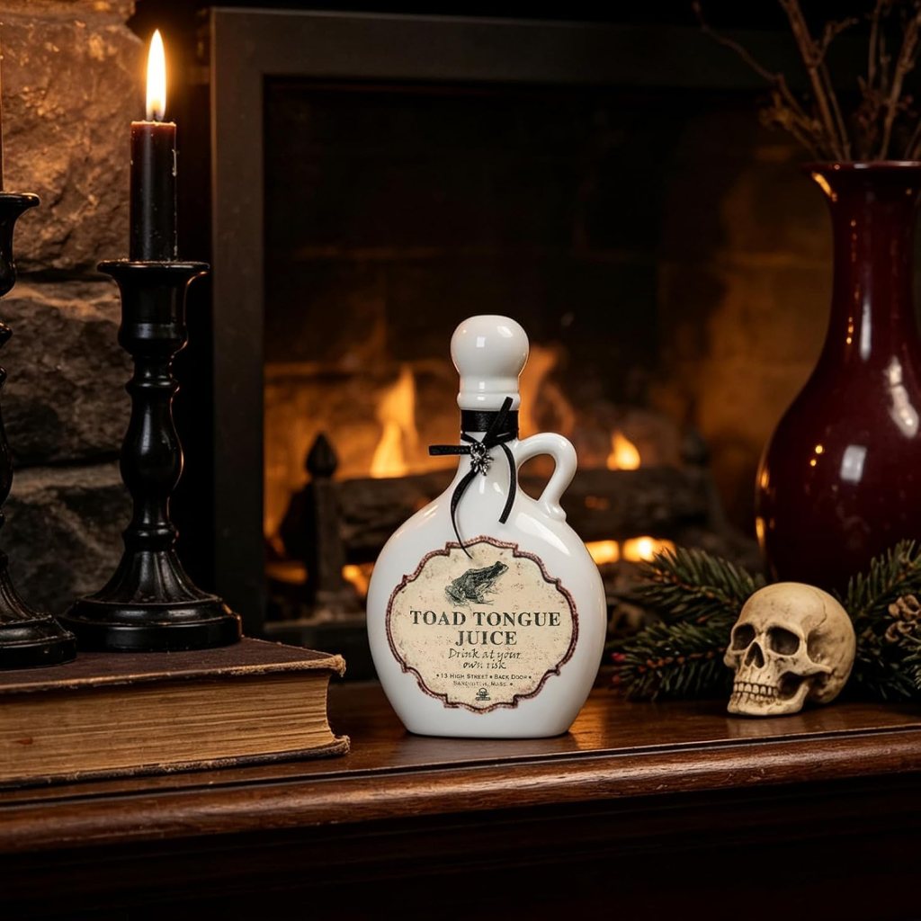 A decorative bottle labeled 'Toad Tongue Juice' sits on a wooden surface, next to a candle, a skull, and a vase, with a cozy fireplace in the background.
