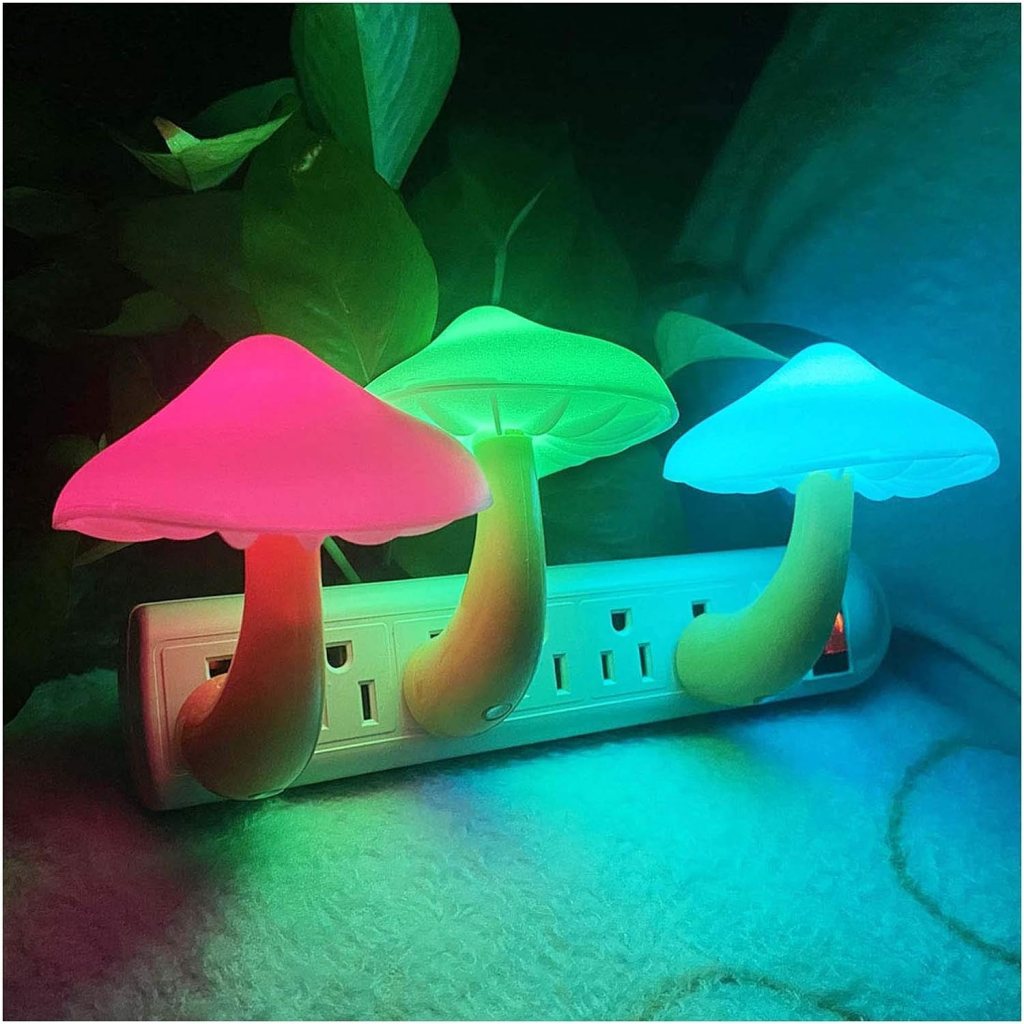 Colorful mushroom-shaped night lights in pink, green, and blue, plugged into a power strip with a soft, ambient glow.