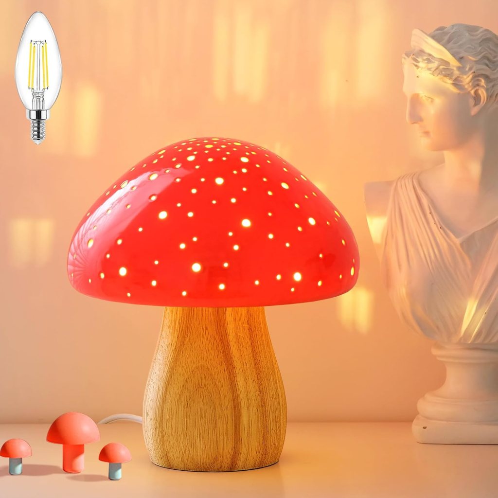 A red mushroom-shaped lamp with a wooden base, glowing with dotted light patterns, alongside small decorative mushroom figurines and a classical statue in the background.