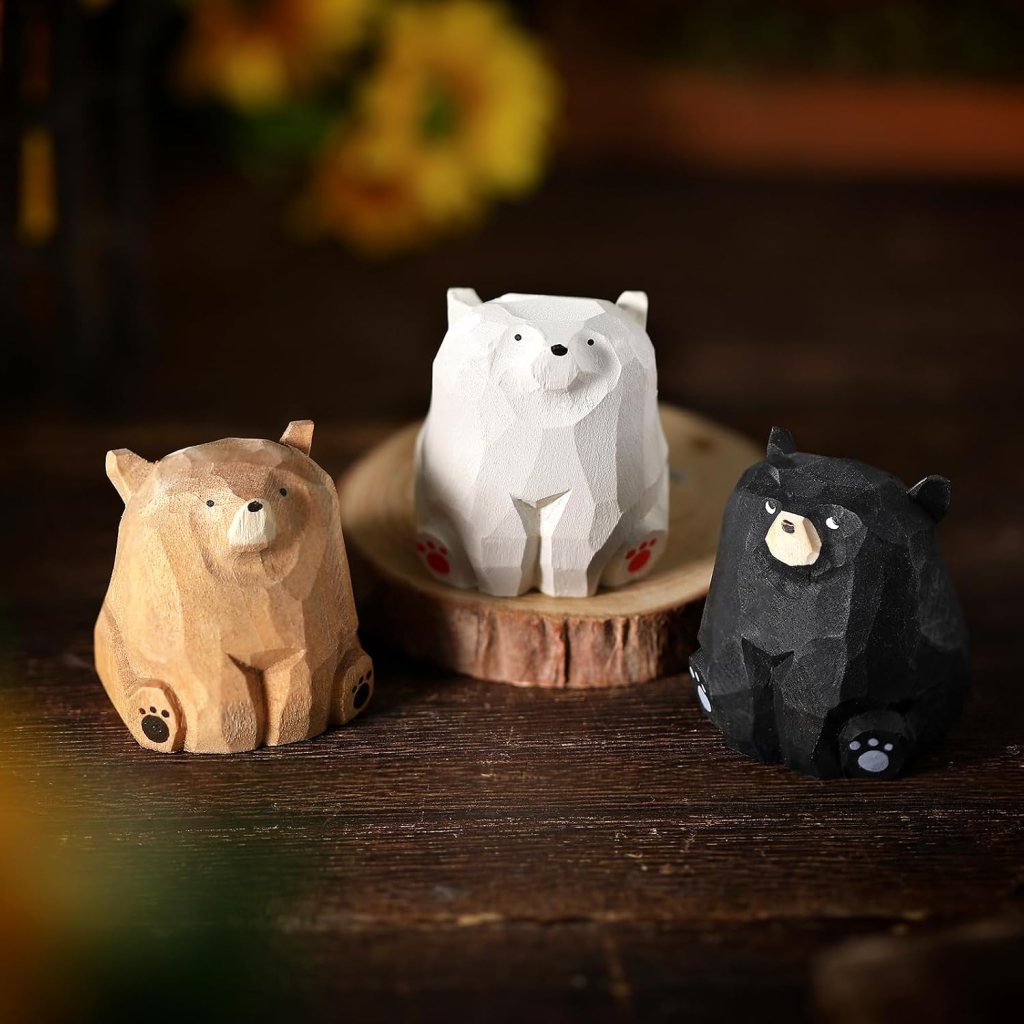 Three decorative bear figurines made of wood, featuring a brown bear, a white bear, and a black bear, placed on a wooden base.