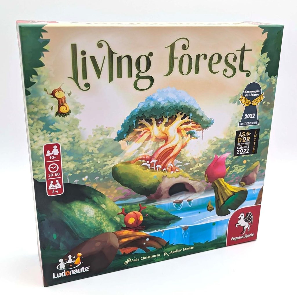 Board game box for 'Living Forest', featuring vibrant artwork of a mystical forest with a large tree, stream, and colorful creatures, including a snail and flowers. Includes age and player information.