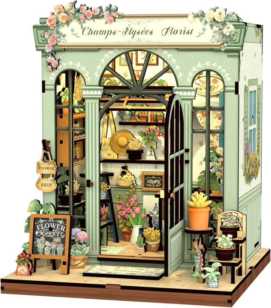 A charming flower shop titled 'Champs-Élysées Florist,' featuring a green storefront adorned with flowers. Inside, various plants and flower arrangements are displayed alongside a welcoming sign. A flower market sign is visible outside.