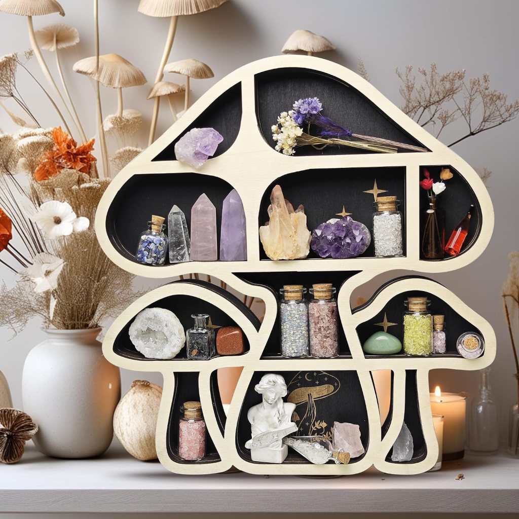 A wooden display shaped like a mushroom featuring various crystals, gemstones, and decorative jars, with a backdrop of dried flowers and candlelight.