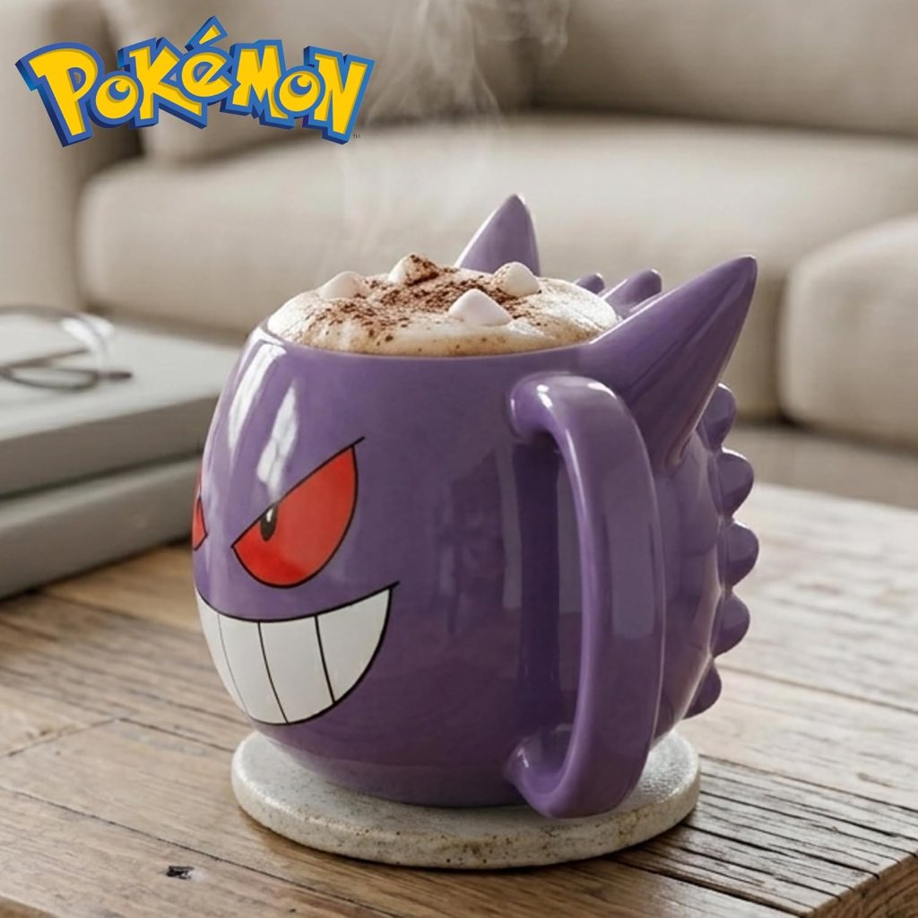 A purple Pokémon-themed mug designed to resemble the character Gengar, filled with a hot beverage topped with marshmallows and cocoa, placed on a wooden table.