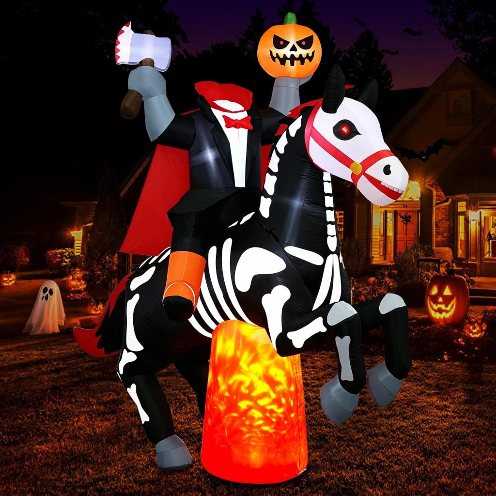 A large inflatable Halloween decoration featuring a skeleton figure dressed as a vampire, riding a black and white horse. The skeleton holds an axe, and there is a jack-o'-lantern with a spooky face on top of its head. The scene is illuminated by an orange glowing light, with a haunted house and ghost decorations visible in the background.