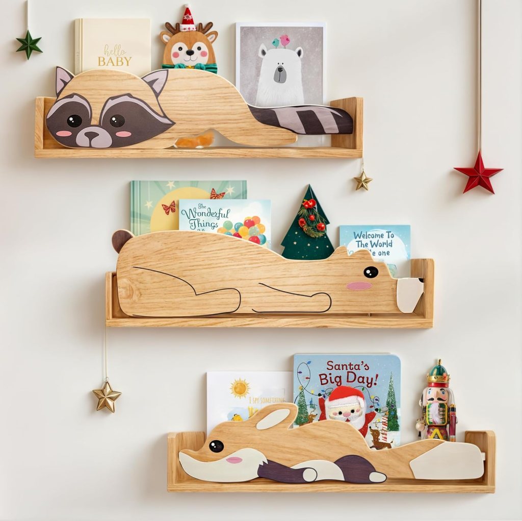 A playful wooden bookshelf shaped like animals, featuring a raccoon, dog, and fox, displaying colorful children's books and decorative elements such as a small tree and stars.