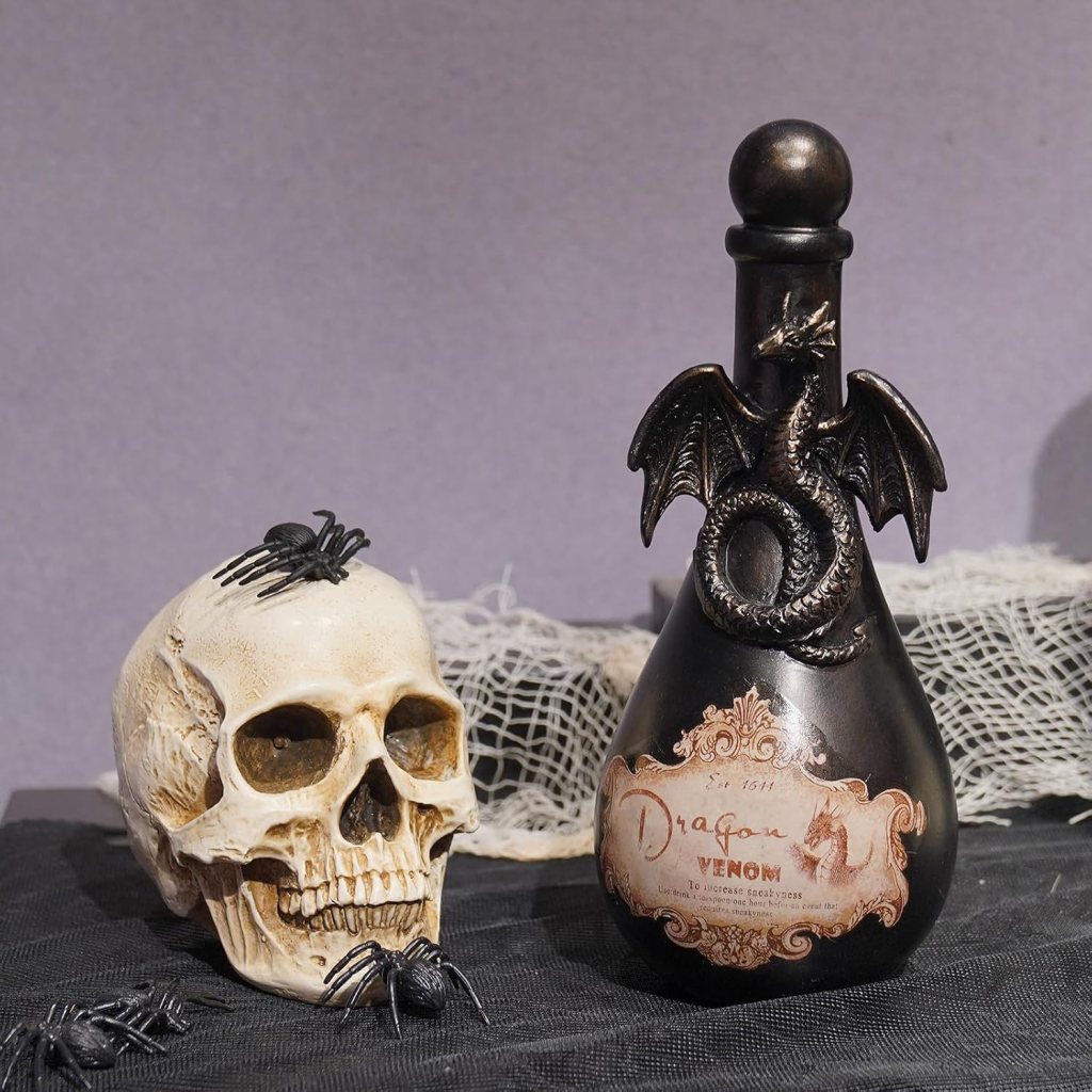 A decorative black bottle labeled 'Dragon Venom' featuring a dragon motif, alongside a decorative skull with fake spiders on it, set against a dark background.