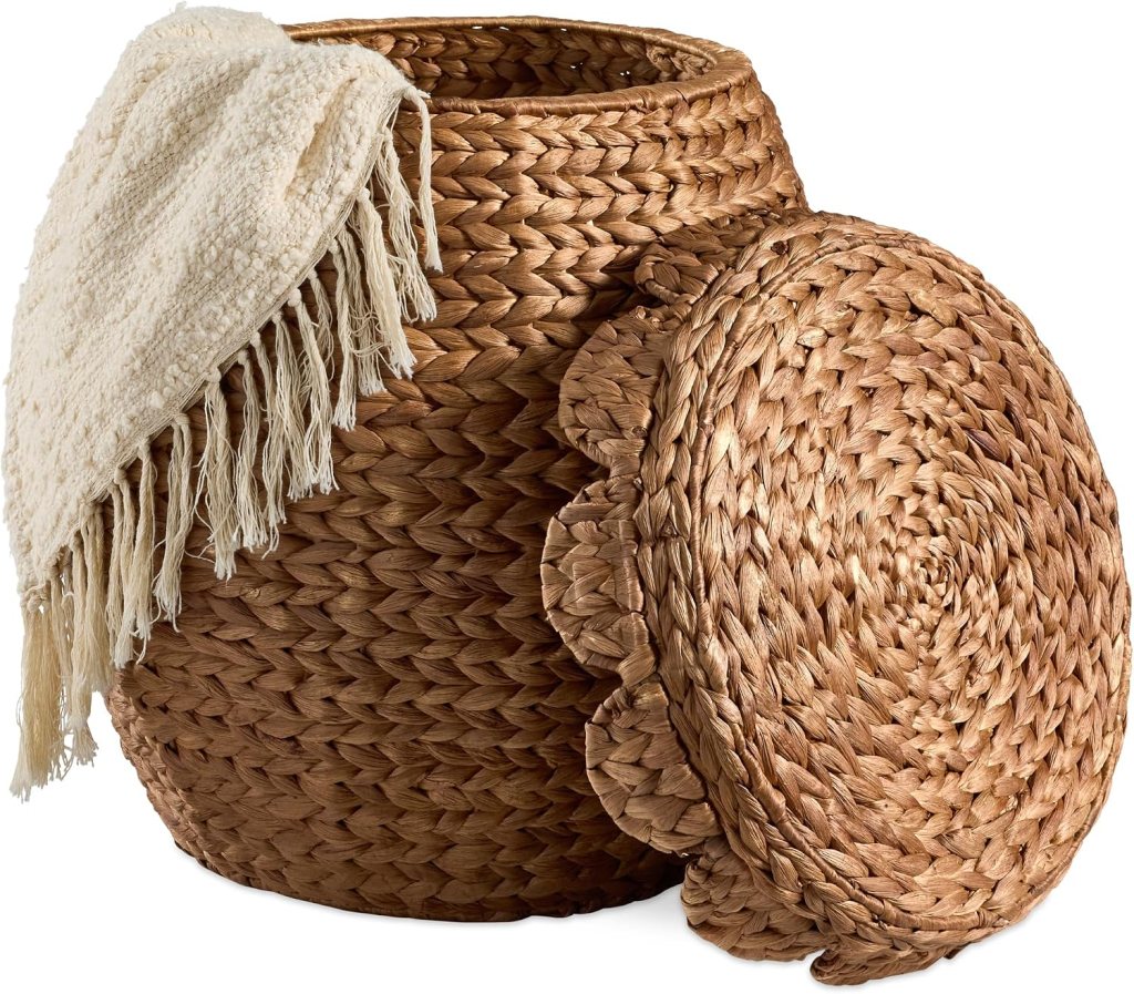 Woven storage basket with a lid and a white blanket draped over the side.