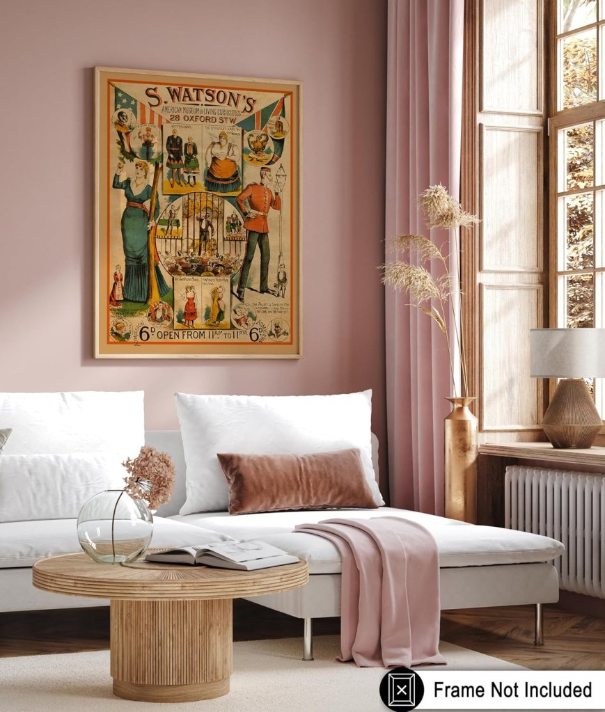 A vintage poster featuring 'S. Watson's American Museum of Living Curiosities' displayed on a wall in a modern living room. The room has neutral-toned furniture, including a white sofa with pillows and a round wooden coffee table with a glass vase and a book.