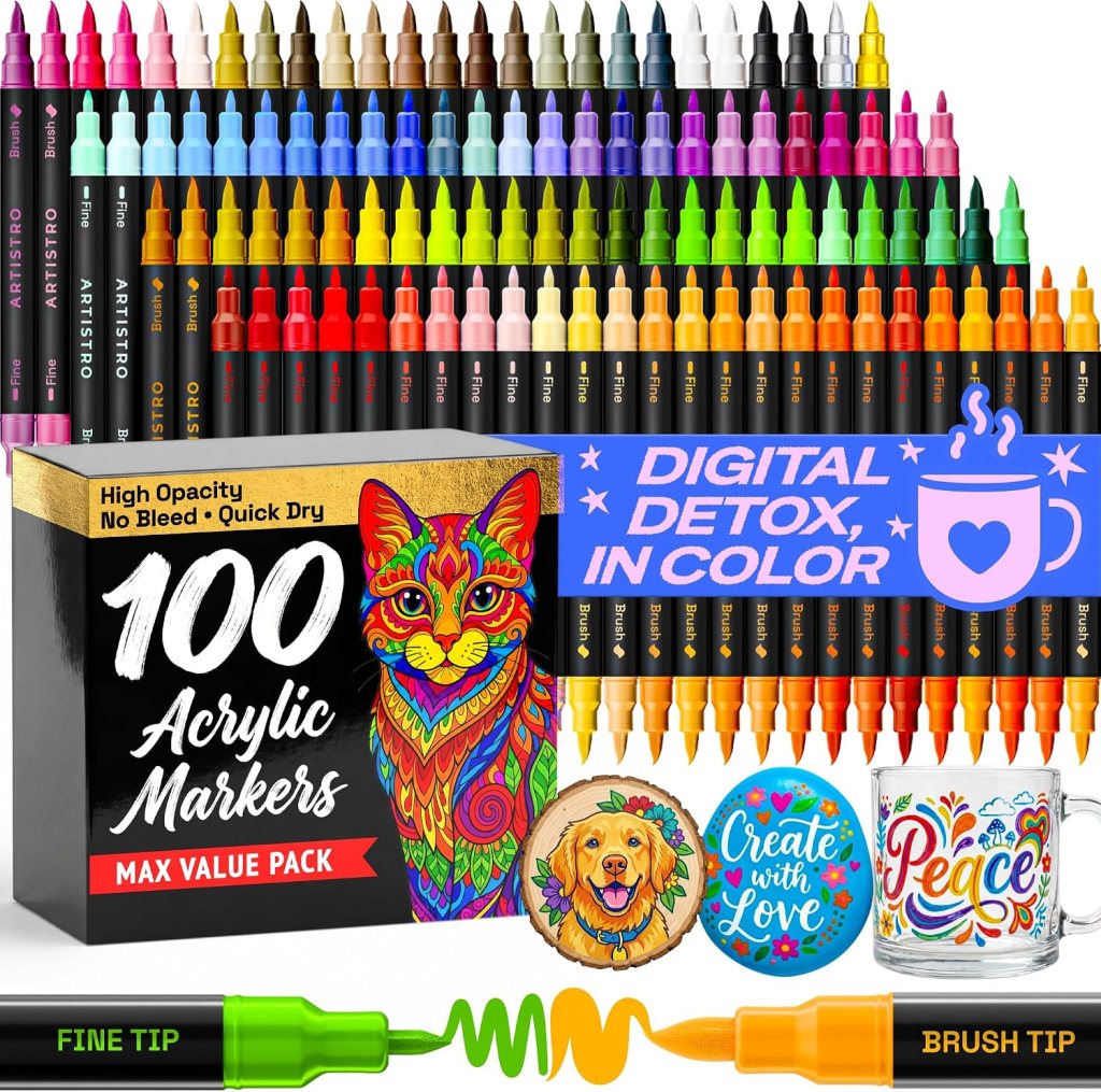 A box of 100 acrylic markers with vibrant colors, featuring fine and brush tips. Includes a colorful cat illustration on the box and decorative items such as a wooden piece with a dog, painted rocks, and a mug with colorful designs. Text highlights 'Digital Detox, in Color'.