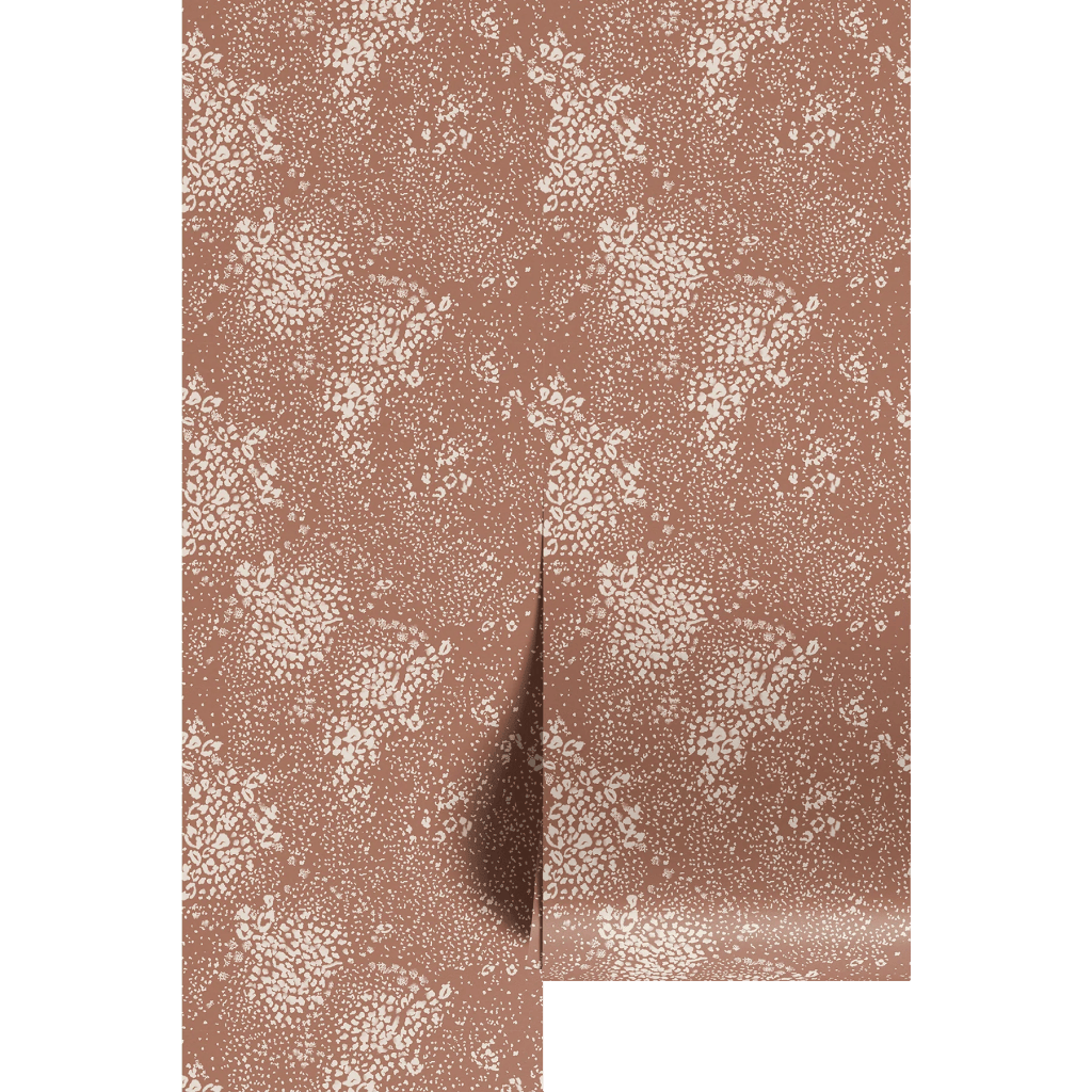A close-up of a textured fabric featuring a brown background with white floral and leaf patterns scattered throughout.